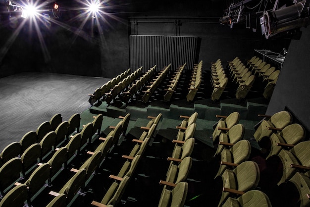 Small auditorium with green armchairs