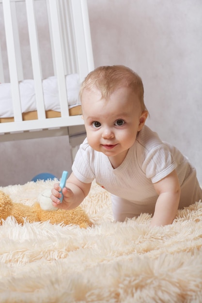 A small baby girl of eight months old is left  alone in her room