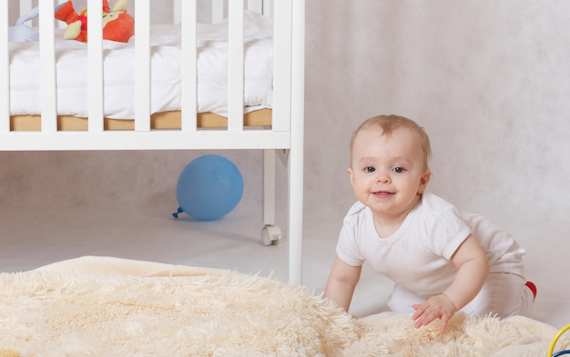 A small baby girl of eight months old is left  alone in her room