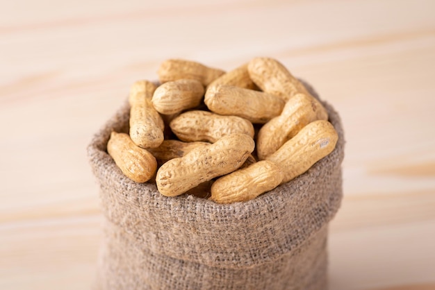 Small bag full of unpeeled peanuts