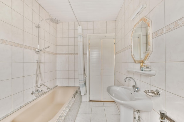 A small bathroom with a tub and a sink