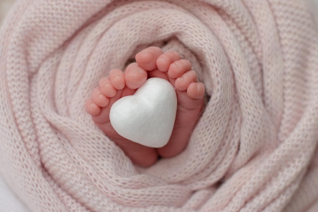 Small beautiful legs of a newborn baby in the first days of life Baby feet of a newborn