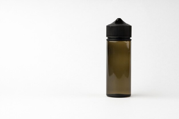 Photo small black glass dropper bottle front view on gray background