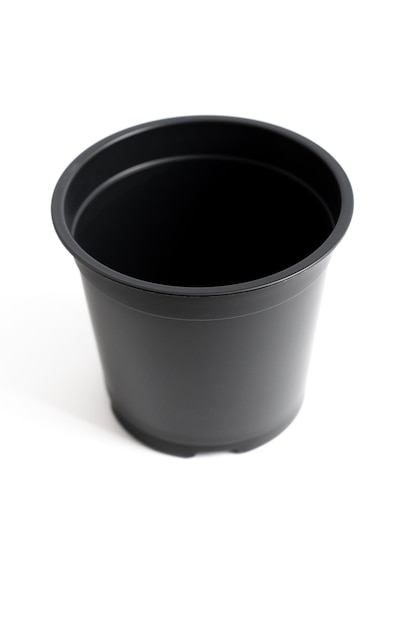 Small black plastic pot for indoor flowers on a white background