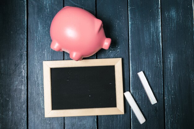 Small blackboard, chalks and piggybank