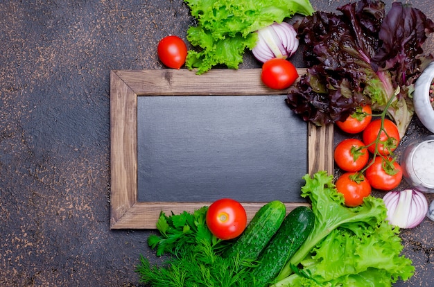 Small blackboard with vegetables for salad around 