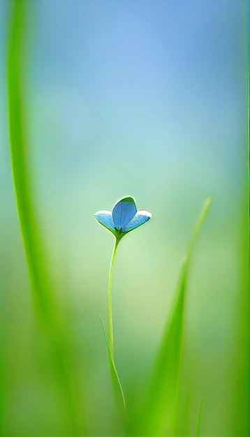 緑の葉の上に座っている小さな青い花の生成ai