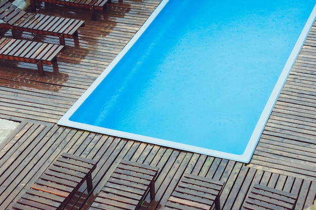 Small blue swimming pool near house