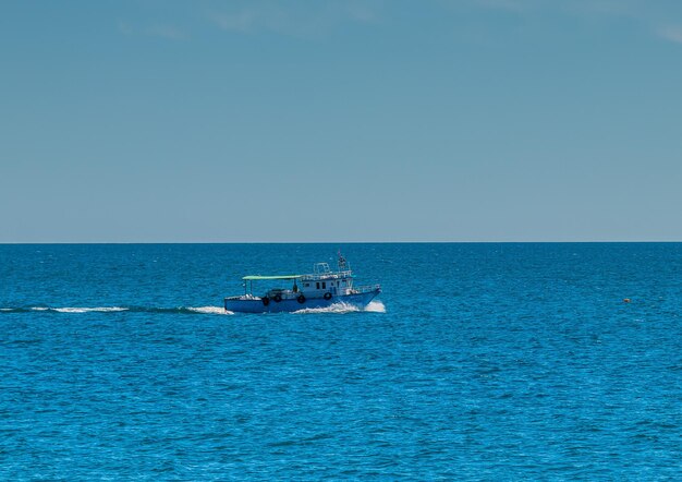 A Small Boat Sailing on the Blue Beach of Mahdia Tunisia