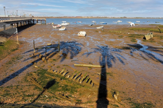 Small boats stranded on the shore of the coast in Huelva Spain