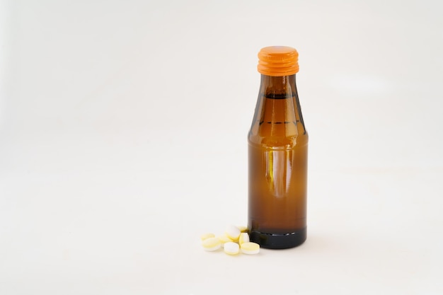 Small bottle of energy drink on monochrome background