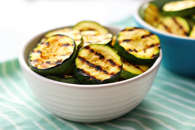 Small bowl filled with zucchini slices with grill marks