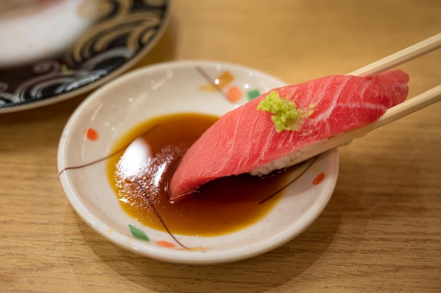 A small bowl of tuna with a piece of meat on it