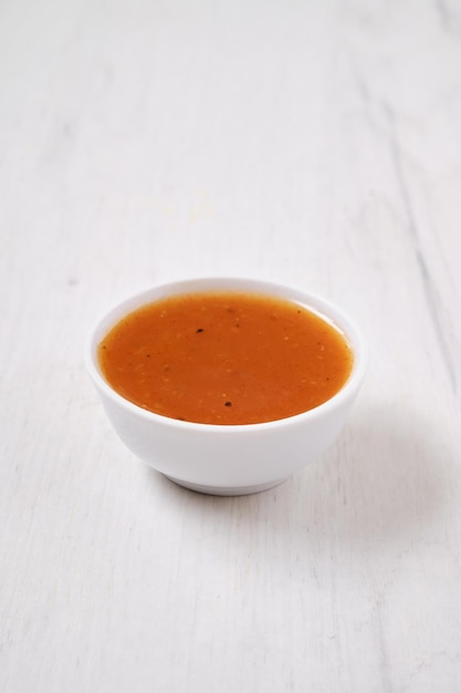 Small bowl with spicy orange sauce for poultry