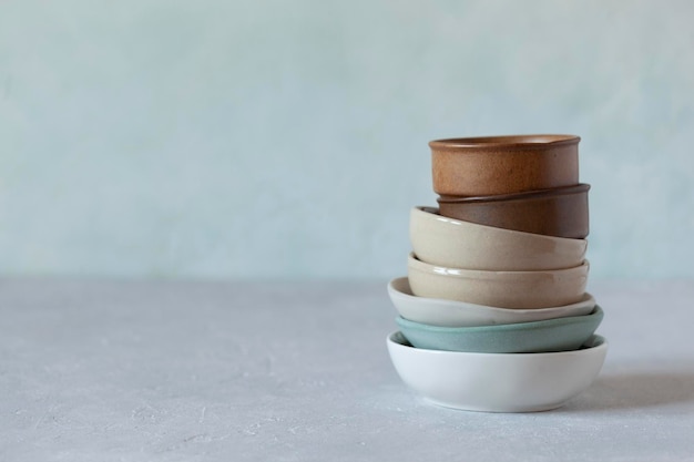 Small bowls on the light green background, rustic style, selective focus