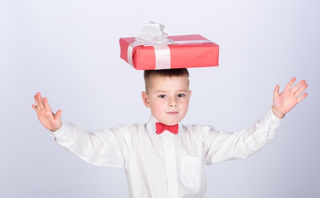 Small boy hold gift box Christmas or birthday gift Dreams come true Buy gifts Happiness and positive emotions Holiday shopping seasonal sale Celebrate new year valentines day Birthday gift