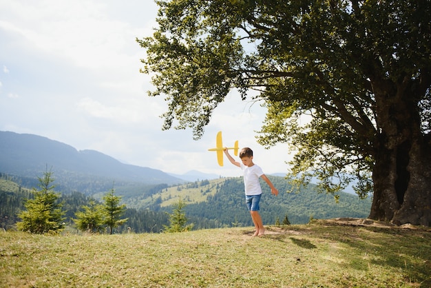 Small Boy Playing with Toy Airplane