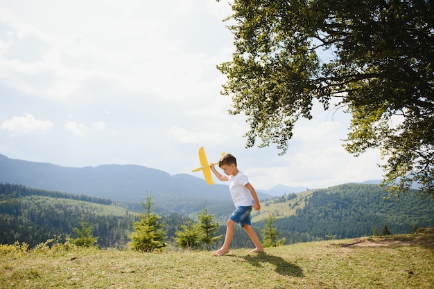 Small Boy Playing with Toy Airplane