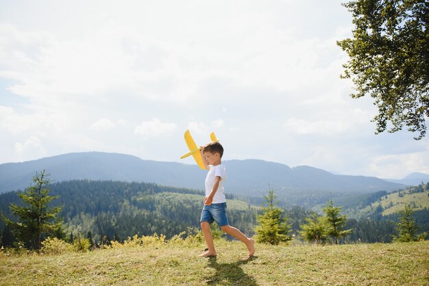 Small Boy Playing with Toy Airplane