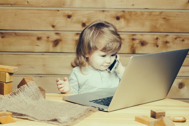 Small boy with computer and phone