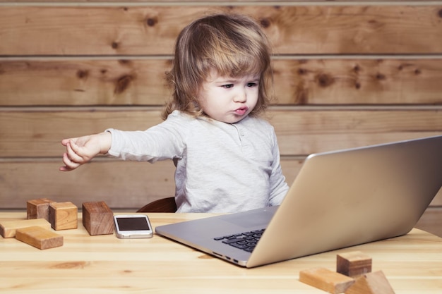 Small boy with computer and phone