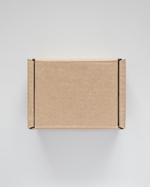 small brown cardboard box on a white background delivery and eco friendly packaging concept