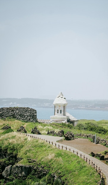 A small building on the hill overlooking the sea