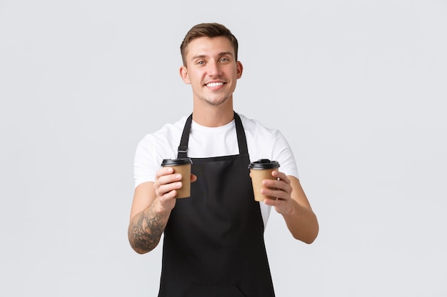 Small business coffee shop cafe and restaurants concept handsome charismatic barista waiter handing ...