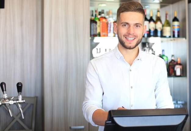 Small business owner working at his cafe