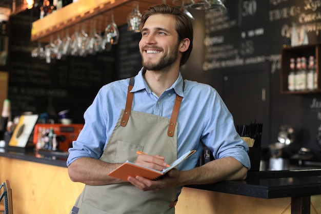 Small business owner working at his cafe.