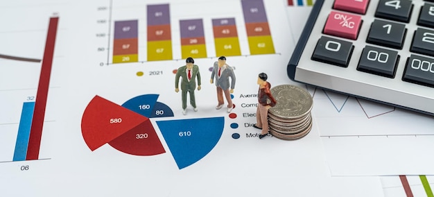 Small business people standing on paper business and financial\
analysis report graph teamwork concept