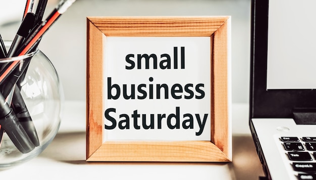 Small Business Saturday text in wooden frame on office table