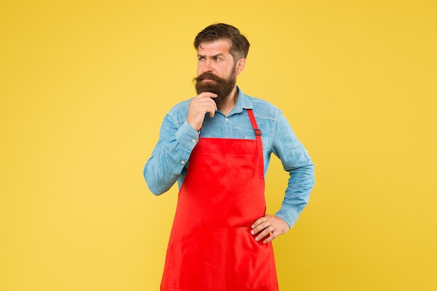 Small business shop owner mature shop assistant professional chef in apron restaurant staff wanted cooking is his hobby bearded man in cook uniform confident male housekeeper Cooking by recipe