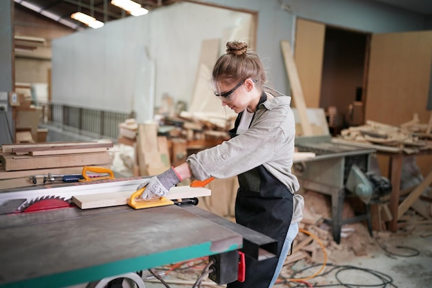 Small business of a young woman Attractive young woman carpenter designer works in workshop