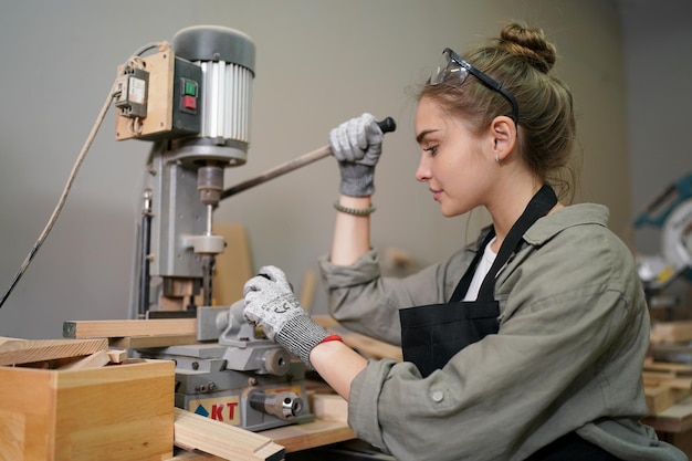 Small business of a young woman attractive young woman\
carpenter designer works in workshop