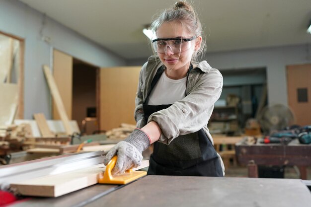 Small business of a young woman attractive young woman\
carpenter designer works in workshop