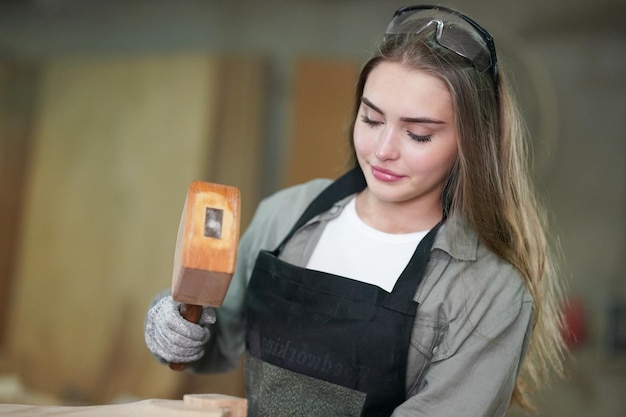 Small business of a young woman attractive young woman\
carpenter designer works in workshop