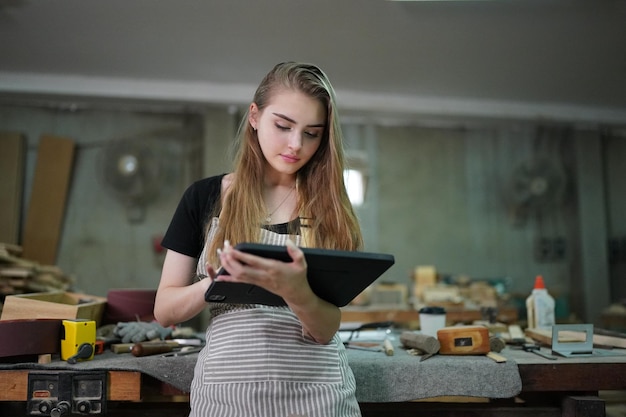 small business of a young woman in furniture workshop background
