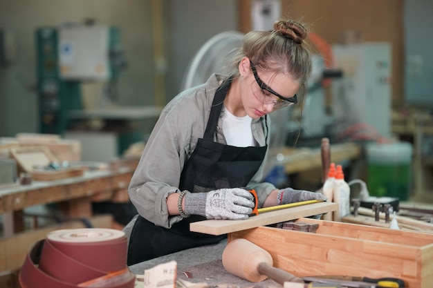 Small business of a young woman in furniture workshop background