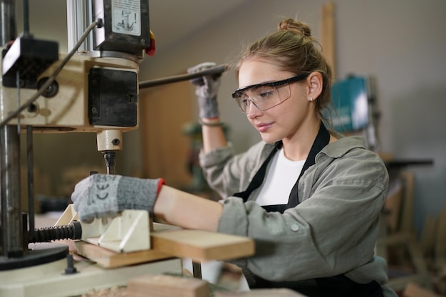 Small business of a young woman in furniture workshop background