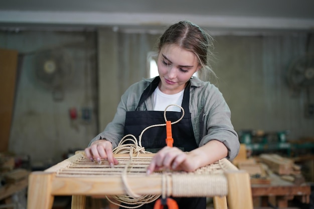 Small business of a young woman in furniture workshop background