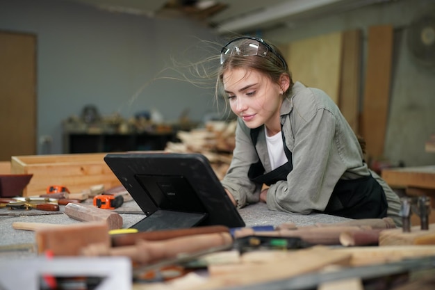 Small business of a young woman in furniture workshop background