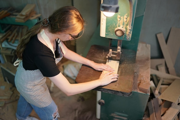 Small business of a young woman in furniture workshop background