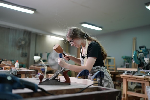 Small business of a young woman in furniture workshop background