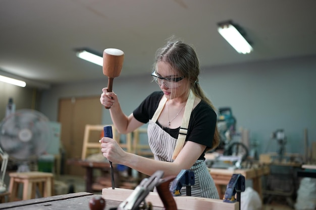 Small business of a young woman in furniture workshop background