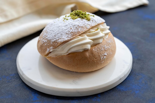 Small cake on the table traditional french flavor with cream in the middle alman pastasi