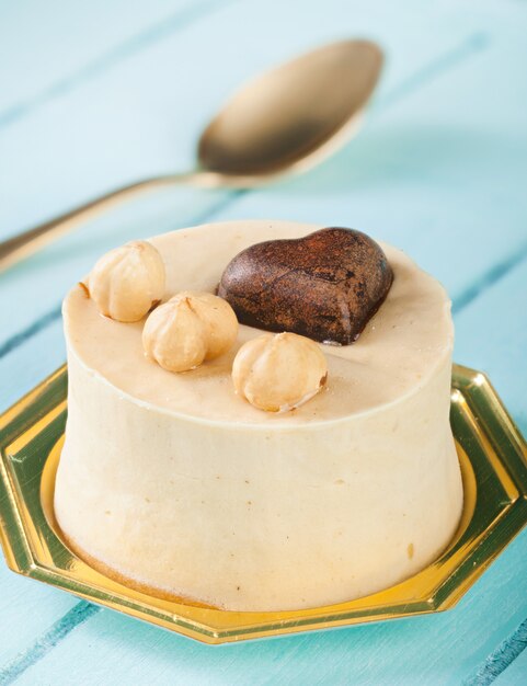 Small cake with hazelnuts and chocolate heart.