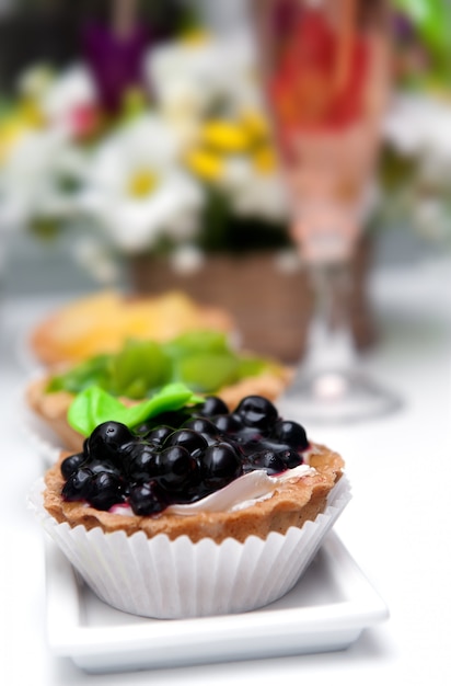 Small cakes with currant on white plate.