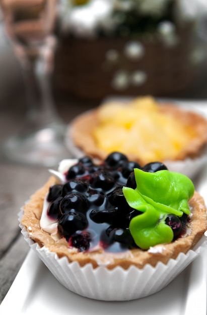 Small cakes with currant on white plate.