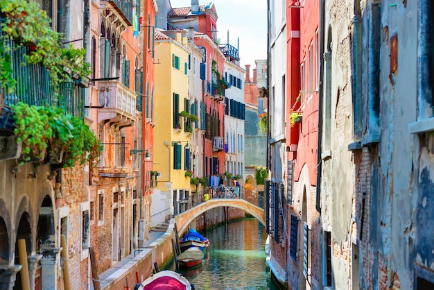 Small canal and bridge between houses in Venice, Italy